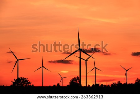 Wind turbine power generator silhouette at sunset