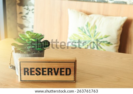 A reserved sign on a table at coffee cafe