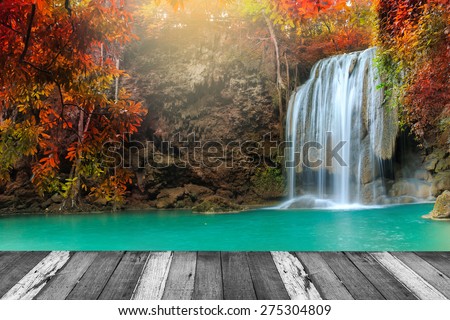 Beautiful waterfall in deep forest and wood pier at Kanchanaburi, Thailand