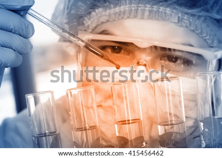 Chemist is analyzing sample in laboratory room.