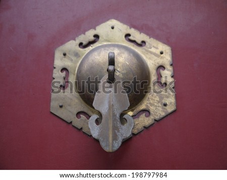 Ancient Chinese door knob.  It is a picture of ancient Chinese knob on the red door.