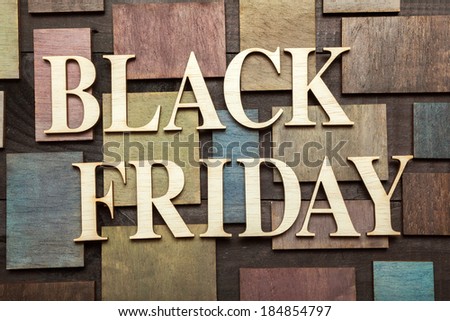 Wooden letters forming words BLACK FRIDAY written on wooden background