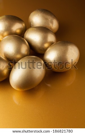 Golden eggs on golden background