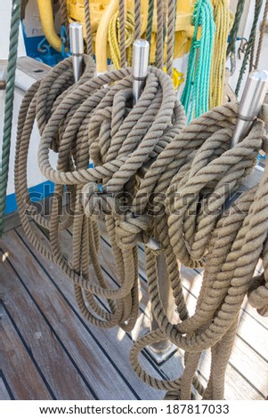 Rope control the sails, tied to a wooden beam