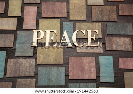 Wooden letters forming word PEACE written on wooden background
