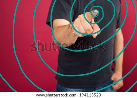 Young casual man pointing something on glass board with marker