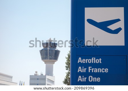 ATHENS, GREECE - JULY 22, 2014: departures lounge sign and air traffic control Tower (TWR) from Athens International Airport Eleftherios Venizelos