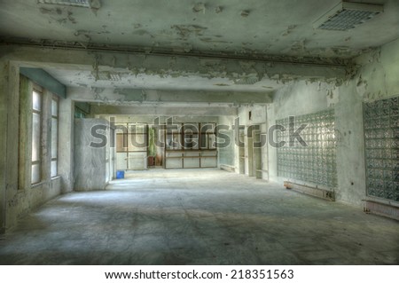 Interior of an abandoned building with rubble and debris. Deserted old hospital