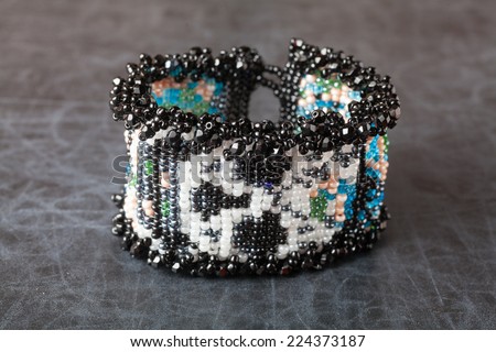 Jewelry made from beads. Bracelet on a dark surface