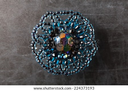 Jewelry made from beads. Ring on a dark surface