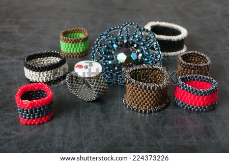 Jewelry made from beads. Rings on a dark surface