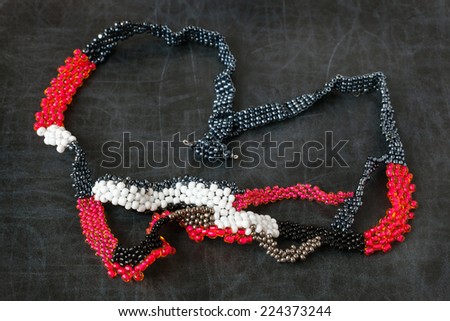 Jewelry made from beads. Bead Necklace on a dark surface.