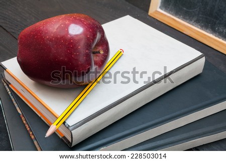Apple on books and chalkboard for background