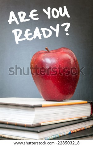 Apple on books and Are you ready? handwritten on the chalkboard in the background