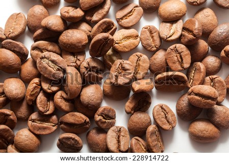 Roasted coffee beans pile on white background