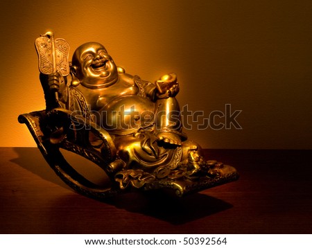 Hotei - chinese god of wealth, prosperity and happiness seating in the rocking-chair. Ancient figurine