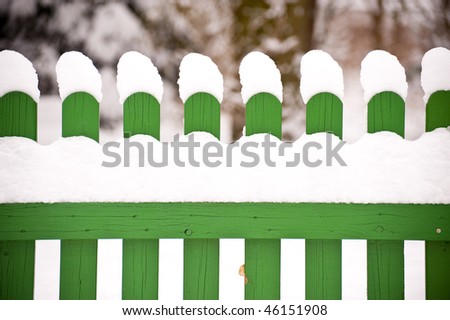 snow covered fence in winter