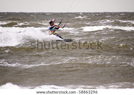 ST. PETER-ORDING, GERMANY - JULY 24: Professional kite-surfer Gunnar Biniasch, Germany, demonstrating his ability on the Palmolive Kitesurf Worldcup 2010, July 24, 2010 in St. Peter-Ording, Germany