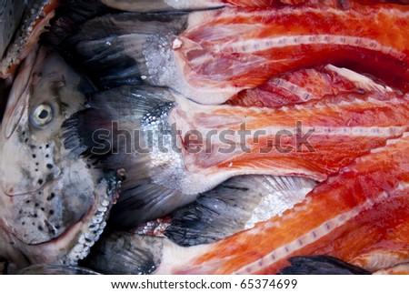 filleting salmons in a fish market hall