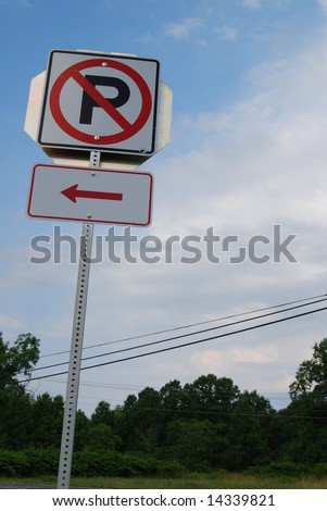 A no parking sign with a sky background.