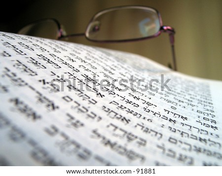 the bible and glasses macro photo of the hebrew letters