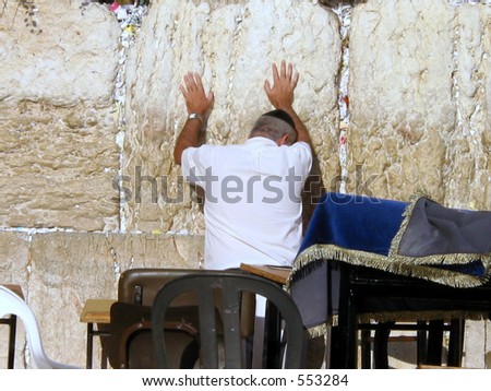 A Jewish person prays with intention at the wailing wall in Jerusalem israel