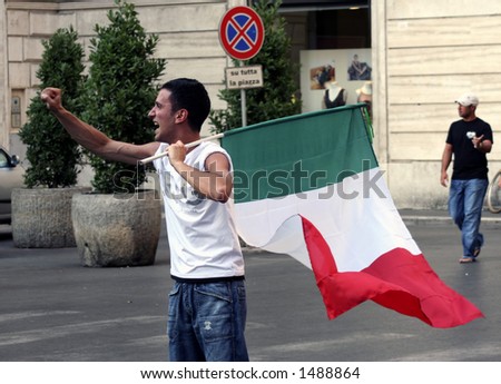 Italian fan is celebrating with the Italian flag after Italy won a game in the world cup championship