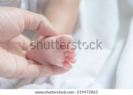 Baby feet on father hand, Love