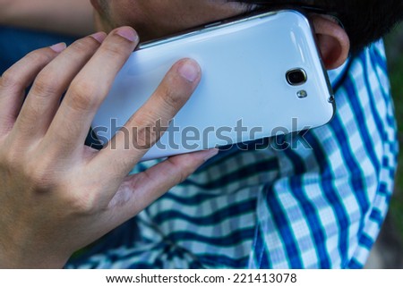 Close up man using mobile smart phone  background