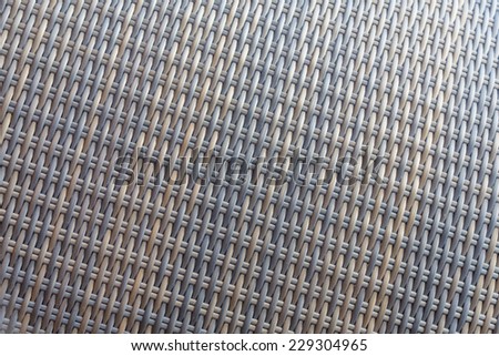 Synthetic rattan texture weaving background as used on outdoor garden furniture.