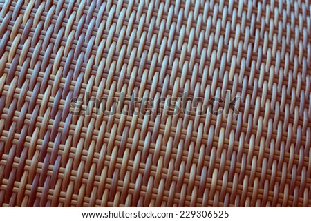 Synthetic rattan texture weaving background as used on outdoor garden furniture.