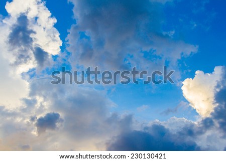 Dainty wispy pale salmon pink and golden yellow clouds at sunset background
