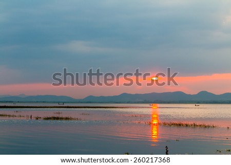 sunset above the  river with mountain far away