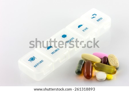 pills and vitamins in white pill box ,daily take
