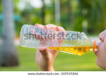 Woman Drinking Green Tea Outdoors. Summer Background. with green bokeh