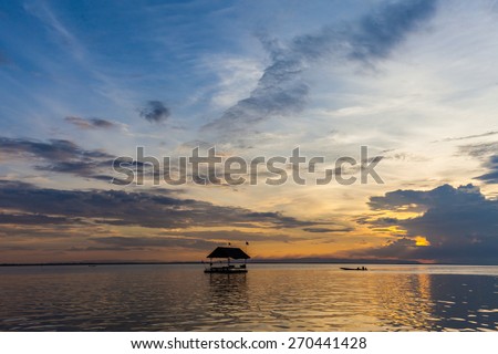Floating house on the embankment with Sunset Background