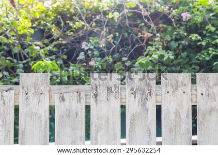 White old wooden fence with flower and tree background