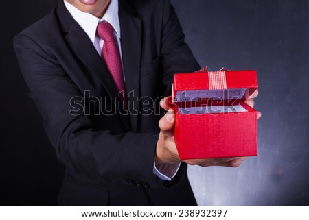 Business man holding a gift box