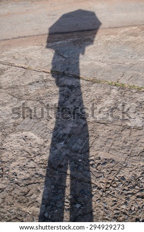 Shadow of an umbrella on the street