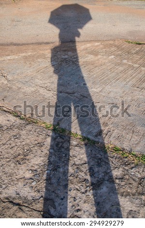Shadow of an umbrella on the street