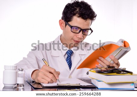 Doctor reading a medical book,Doctor Filling The Medical Form (shallow DOF)