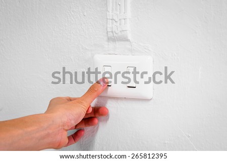 Hand turn off switch lights on white home wall ,Concept for save the world