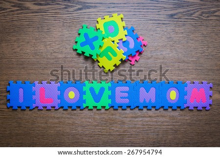 i love mom Plastic ABC text jigsaw puzzle,on wood table from child autism.