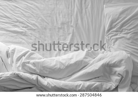 Top view of white bedding sheets and pillow