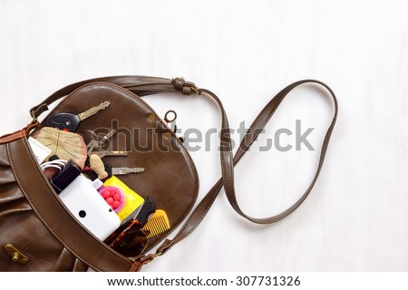 Women bag with cosmetics,phone, medicine and  condom (women save sex concept)