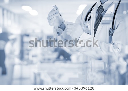 Doctor using a syringe on blurred nurse in emergency room  , concept for healthcare and medicine