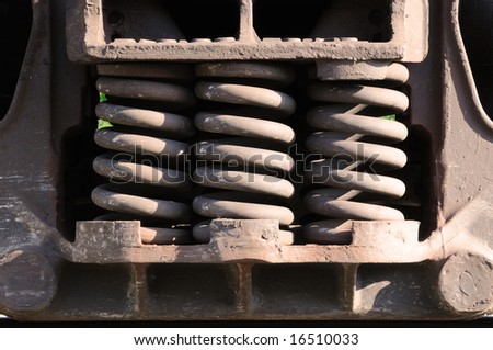 a trio of heavy-duty springs on the side of a train car