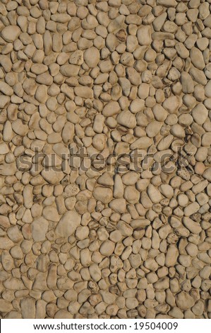 A wall of rounded pebbles packed closely together