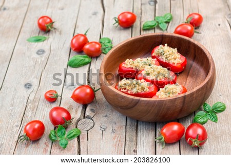 Stuffed tomatoes in a round wooden bowl