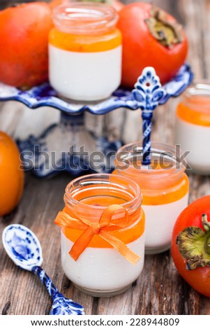 Italian dessert panna cotta in a jar with persimmon topping